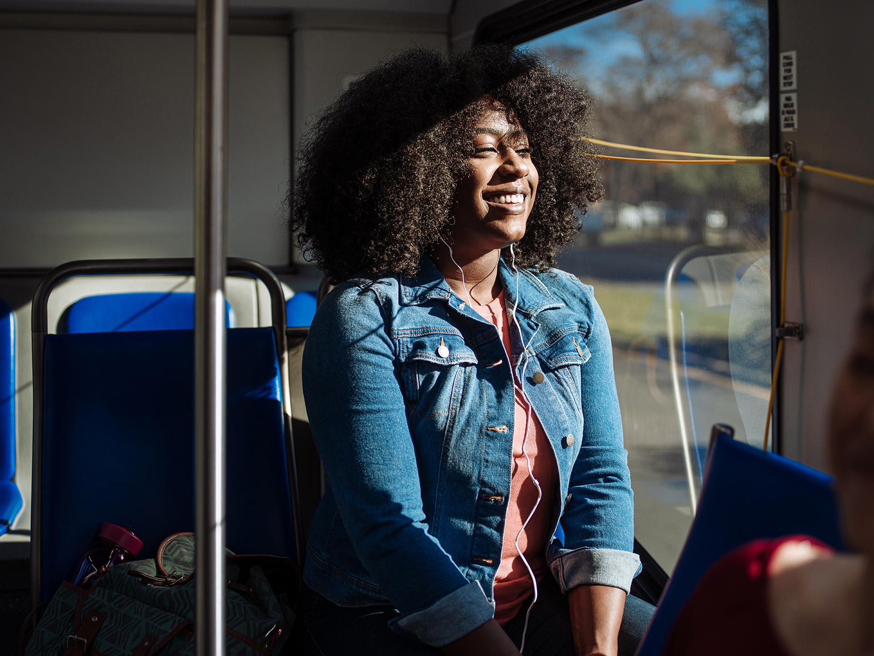 A rider smiles on a VIA bus in San Antonio, TX by commercial photographer Josh Huskin