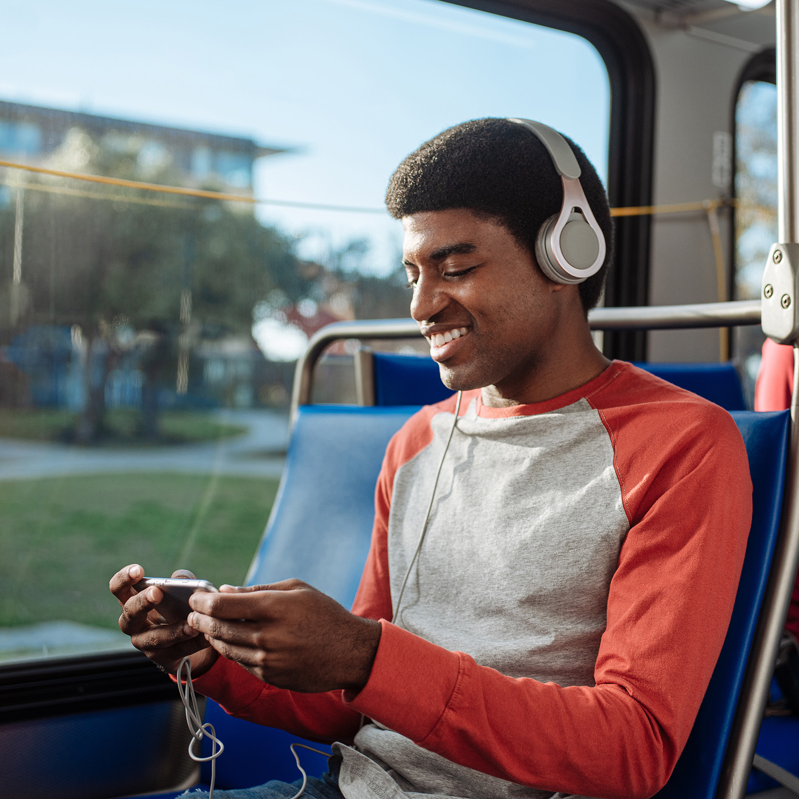 A rider smiles on a VIA bus in San Antonio, TX by commercial photographer Josh Huskin